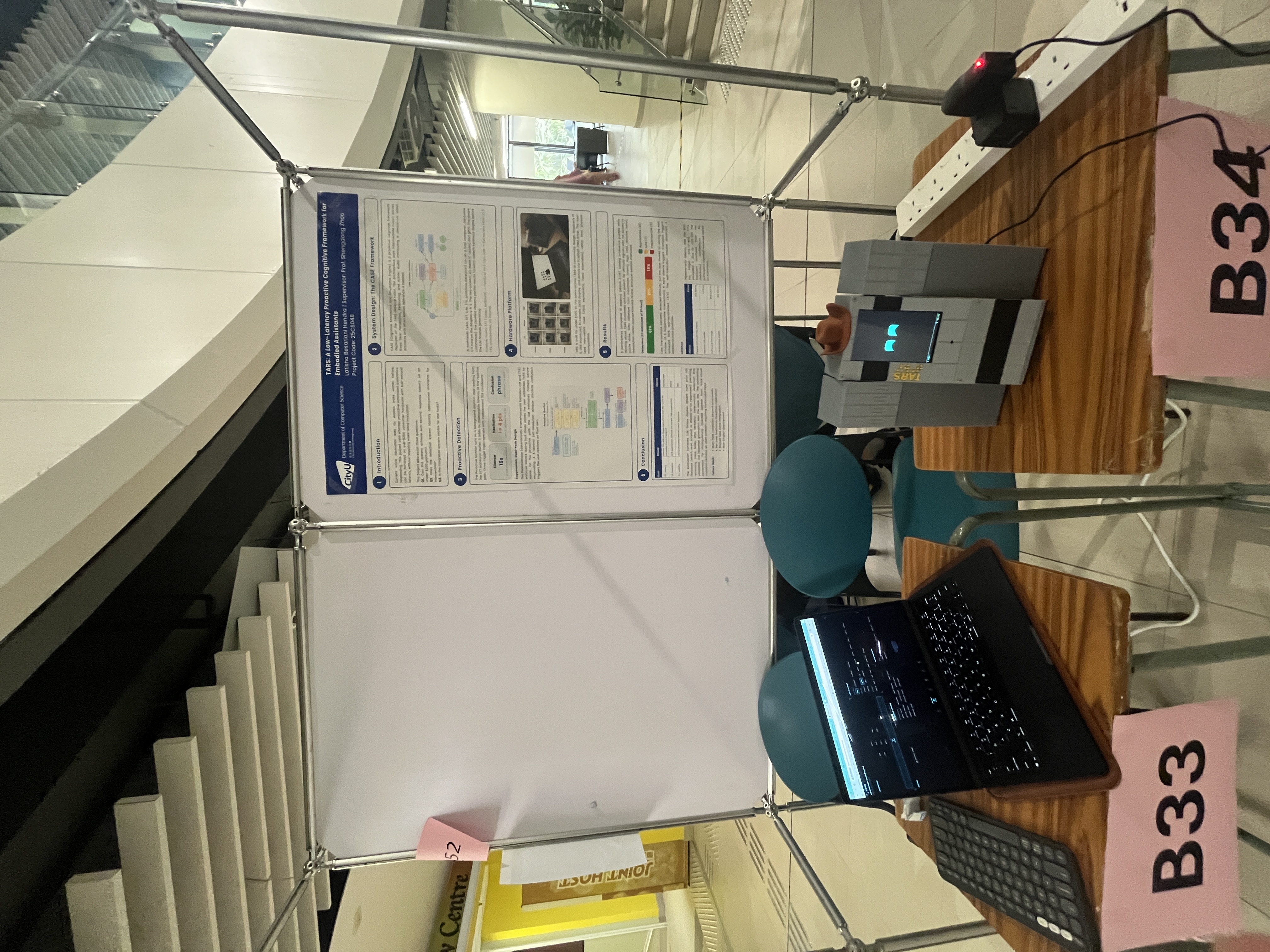 FYP exhibition booth with TARS, poster, and laptop